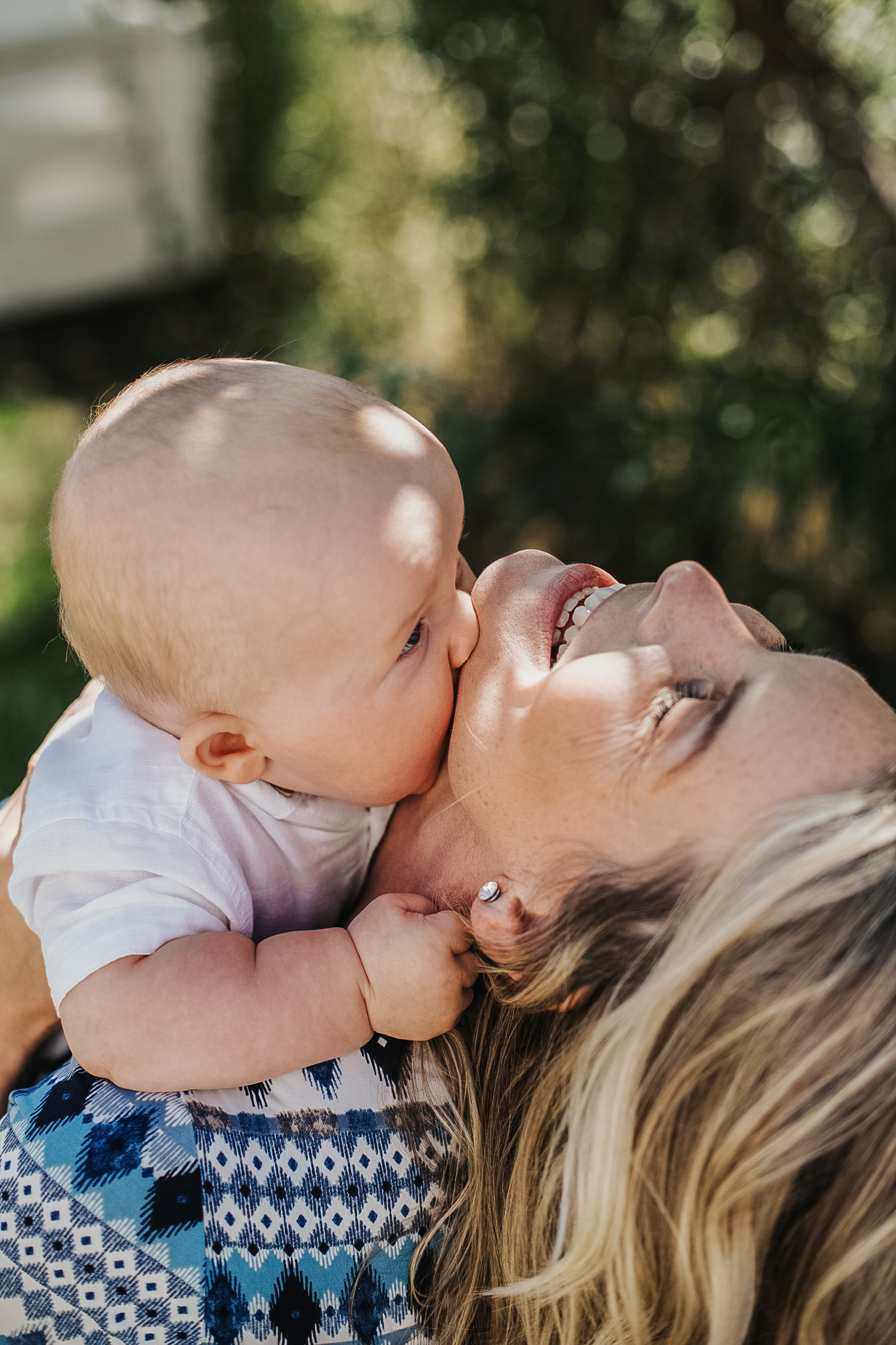 A mother and her baby cuddling during a outdoor lifestyle photography session in Bayside, Melbourne.